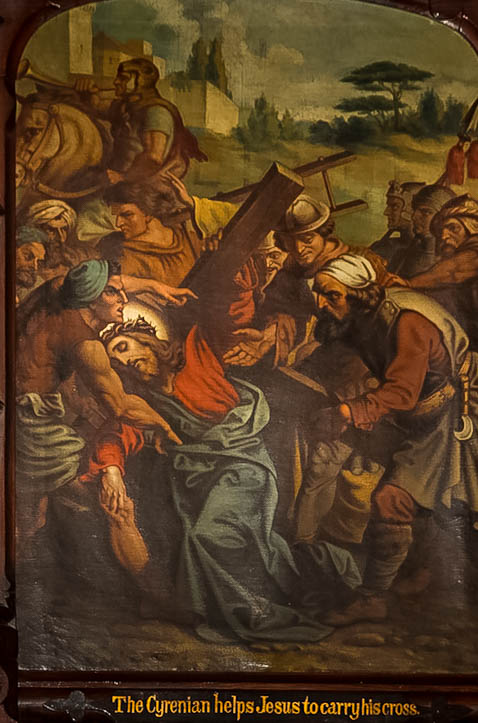 Simon of Cyrene helps to carry the Cross