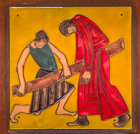 Simon of Cyrene helps to carry the Cross